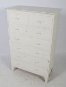 A contemporary pine chest of drawers. Painted white, two short drawers over five long drawers.