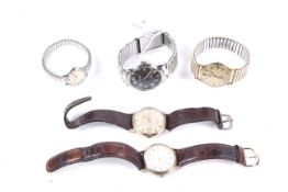 Omega De Ville, a lady's stainless steel round bracelet watch and four gentleman's watches.