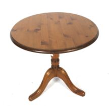 A contemporary pine circular table.