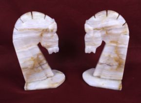 A pair of marble bookends modelled as horse heads.