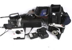 An assortment of vintage film cameras. Including a cine camera, etc.