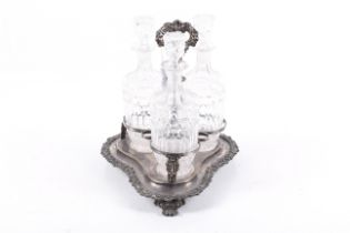 A silver-plated three-bottle decanter strand and three clear glass decanters and stoppers.