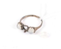 An early 20th century gold and round cabochon moonstone three stone ring.