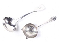 A William IV silver fiddle pattern sauce ladle and a later sifter spoon.