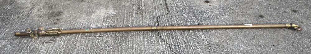 A large metal curtain pole. With rings, one finial.