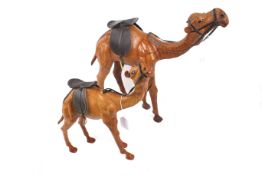Two leather camel figure ornaments. With saddles. Max.