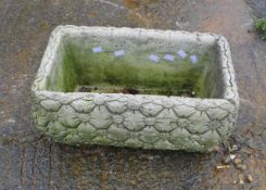 A reconstituted stone rectangular garden planter.