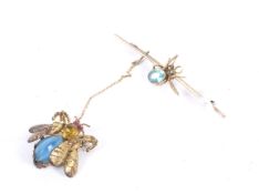 An early 20th century gold and pale-blue stone 'spider' bar brooch.