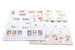 A collection of cigarette cards in albums.
