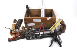A box of assorted hand tools. Including a wet stone, etc.