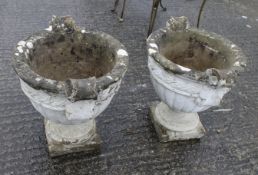A pair of reconstituted stone garden urns.