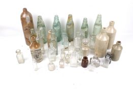 An assortment of vintage glass and stoneware bottles.