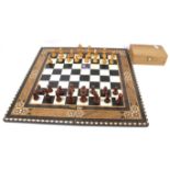 A wooden Staunton chess set and folding board.