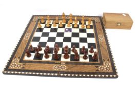 A wooden Staunton chess set and folding board.