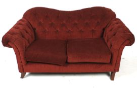 A contemporary two seater button back sofa.