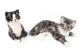 Two small Winstanley china cats. Including a seated size 1 and a recumbent tabby size 3. Max.