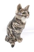A life-like Winstanley china tabby cat. Seated, size 7, with glass eyes.