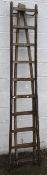A vintage wooden window cleaner's two section ladder.