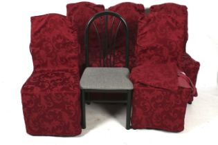 A set of six contemporary dining chairs with covers.