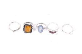 A group of five silver and gem set rings.