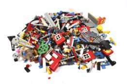 A collection of vintage Lego parts and pieces. Including some mini figures, building blocks, etc.