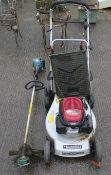 A Mountfield lawn mower and Makita RBC 221 strimmer.