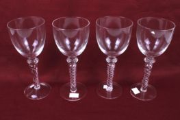 A set of four large contemporary air twist wine glasses.