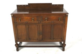 A 1930s carved oak sideboard.