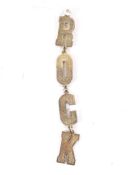 A vintage gilt pendant with textured letters 'ROCK'.