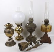 Four 19th century and later oil lamps and a bell.