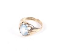 A vintage 9ct gold and oval aquamarine single stone gypsy-type ring.