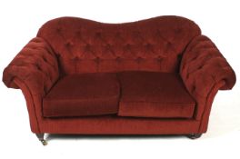 A contemporary two seater button back sofa.