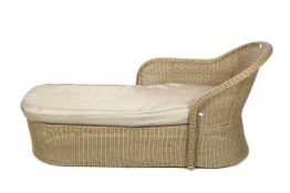 A contemporary wicker day bed lounger.