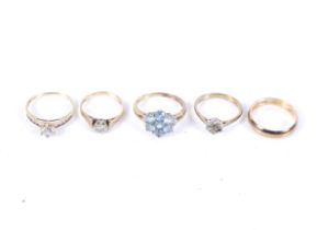 A 9ct gold wedding band and four other gem set and cubic zirconia rings.