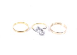 Three gold rings. Comprising a 22ct gold wedding band, hallmarks for Birmingham 1950, 1.