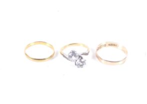 Three gold rings. Comprising a 22ct gold wedding band, hallmarks for Birmingham 1950, 1.
