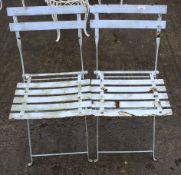 A pair of vintage folding metal garden cafe chairs.