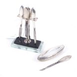 An Art Deco silver mounted and lucite based manicure stand for four pieces.