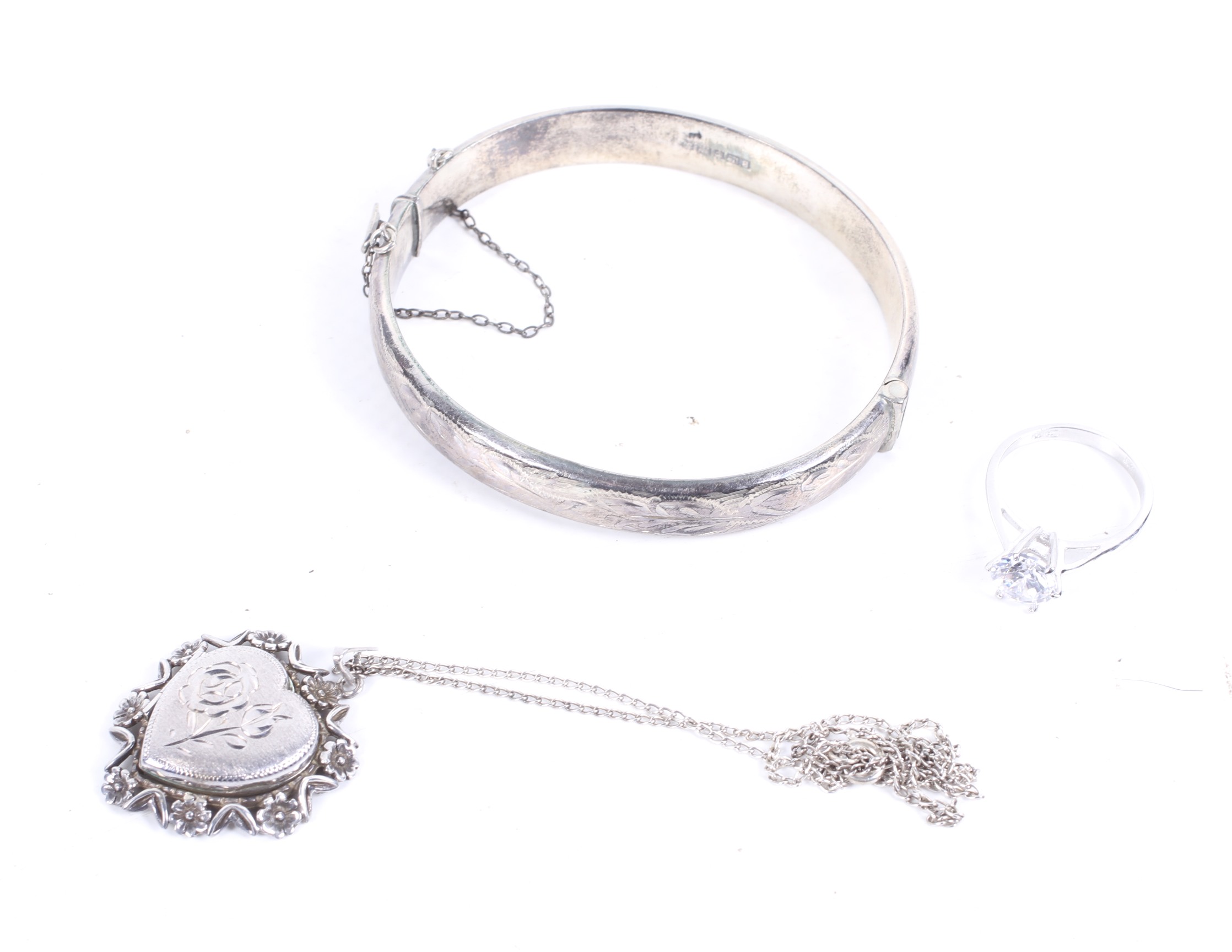 A vintage silver part-foliate engraved hinged bangle and other items.