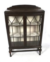 A 1940s bow fronted oak display cabinet.
