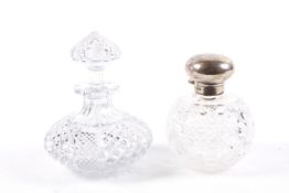 Two clear cut glass scent bottles.