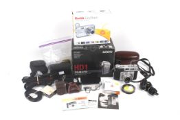 An assortment of digital and film cameras and accessories.
