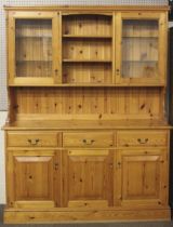 A contemporary two-piece pine kitchen dresser.