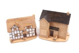 Two large ceramic models of houses.