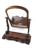 A Victorian bevelled edge toilet swing mirror.
