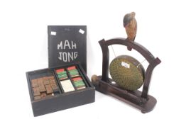 A vintage boxed Mahjong set and a brass gong on stand.