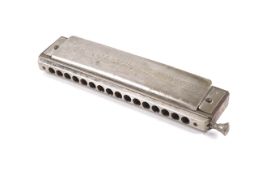 A vintage boxed Hohner 64 Chromonica harmonica.