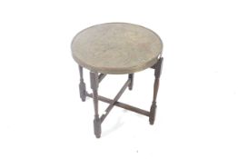 A 20th century brass top folding table.
