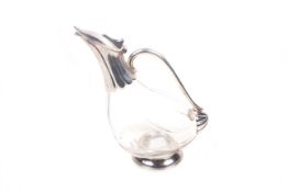 A silverplated novelty glass claret jug modelled as a duck. H24.