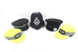 Five Metropolitan police hats.